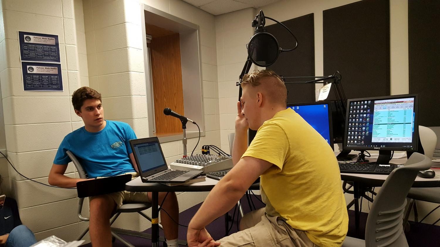 (Left to right) Juniors Cole Stover and Tyler McDonald prep for the upcoming year in Falcon Web Radio sports (Photo by Olivia Lighty).