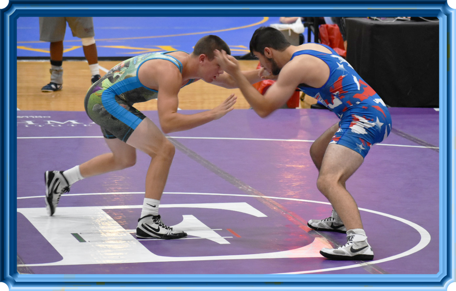 Junior+Brooks+Davis+moves+into+a+wrist+tie+to+control+his+opponent%E2%80%99s+hand.+He+won+the+match.+The+Perry+wrestlers+wore+Alice-in-Wonderland+singlets+%28a+one-piece+wrestling+uniform%29+to+represent+the+Falcons+at+the+special+event.+The+specialty-designed+singlet+featured+a+picture+of+Alice+on+the+front+and+the+Mad+Hatter+on+the+back.+%28Photo+provided+by+Luis+Zepeda+Sr.%29+%0A
