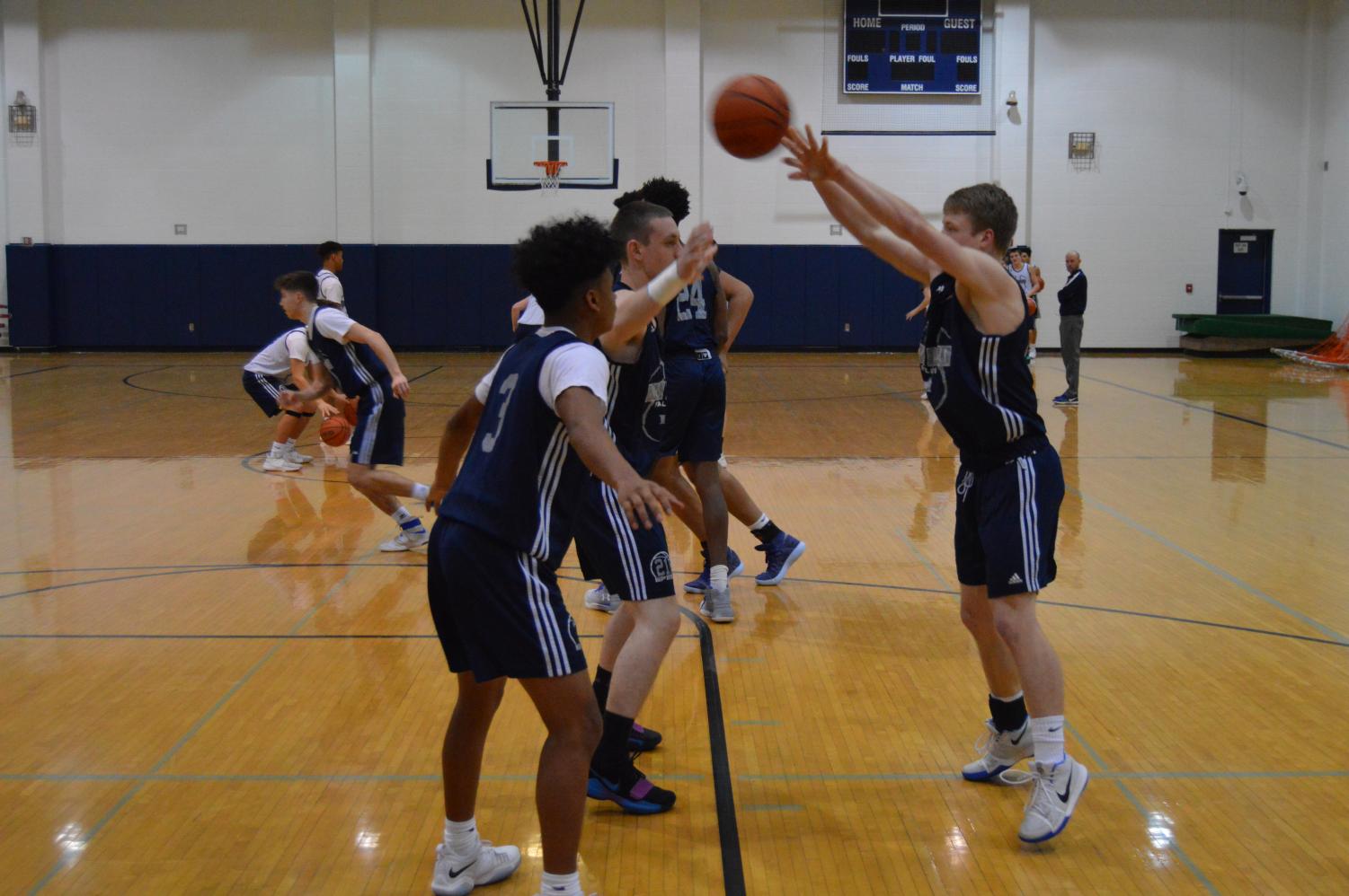 Boys Basketball seniors Adam Taylor, Gabe Patterson and Reggie McDonald during the team practice on Tuesday.