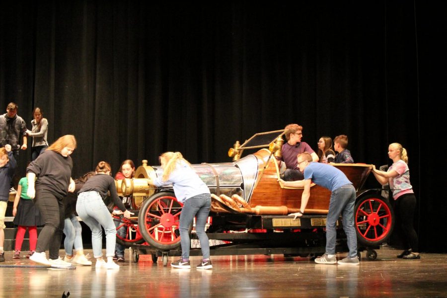 Grandpa, played by sophomore Dominick Heyob, drives onto stage in “Chitty Chitty Bang Bang,” followed by sophomore Maria Miller and freshman Gabe Means, who play old and crotchety inventors (Photo by Alexis Lee).