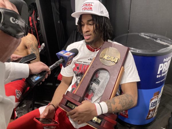 Taylor posses the South Regional Champion trophy during his media session following their victory over Duke on Mar. 31 in Dallas, Texas 
Photo provided by Chip Alexander (The Raleigh News & Observer) 