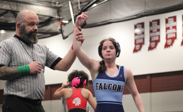 Hailey Schoettle's hand raised in Victory after her match at the Gobbler.