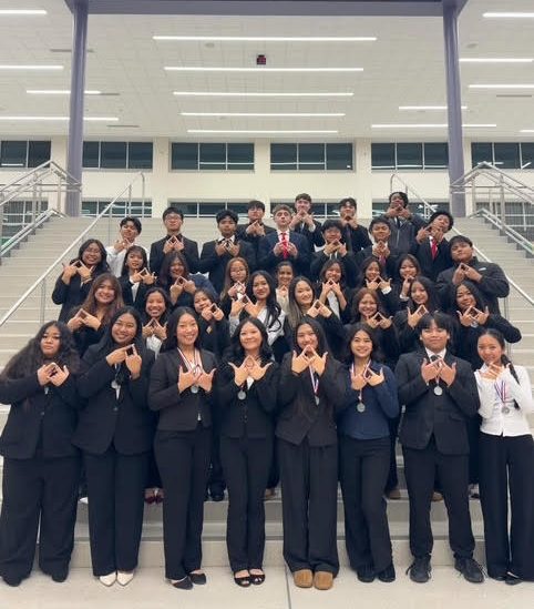 DECA students pose for picture after learning they will advance to state. Photo by Josh Shaffer.