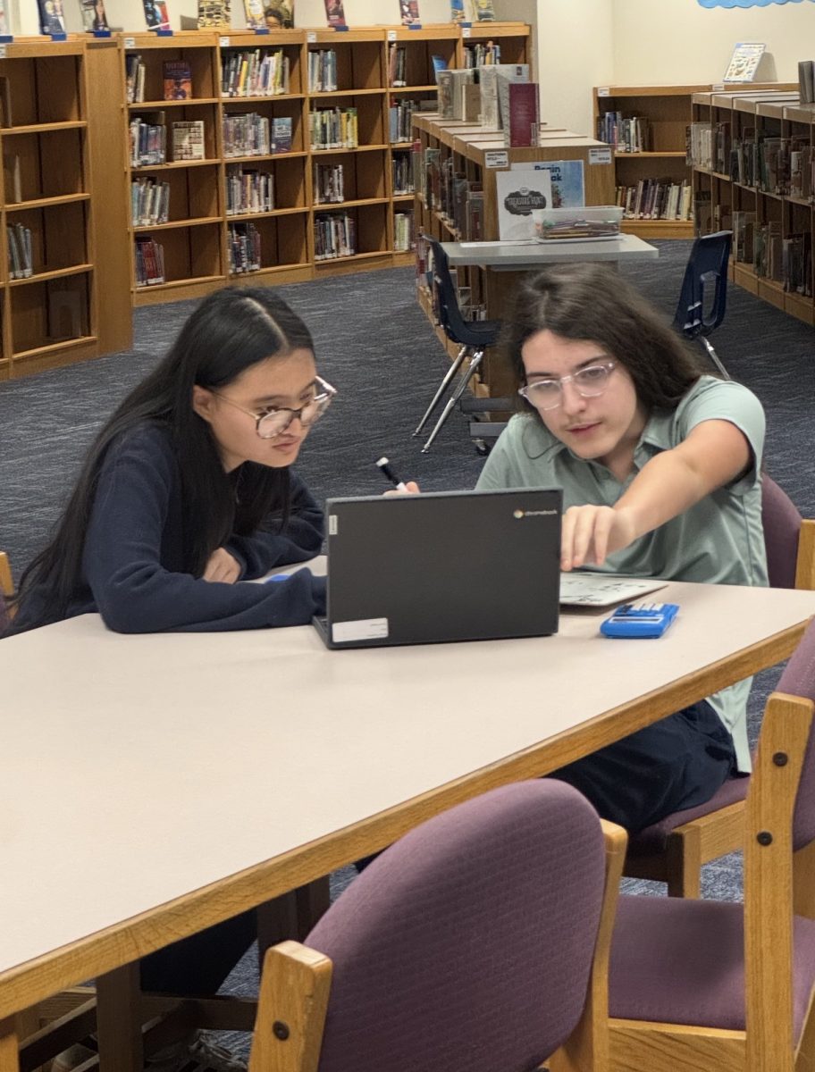 Kathy San helps a middle school student study Geometry at Perry Meridian Middle School.